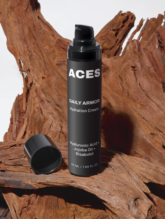 Daily Armor Hydration Cream bottle on driftwood